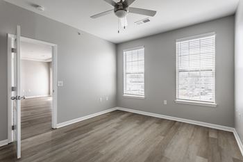 The living room of an empty house with a ceiling fan